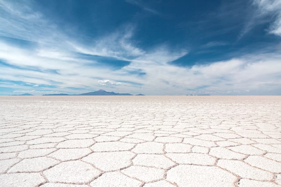 Salar de Uyuni espelhando o céu azul na Bolívia